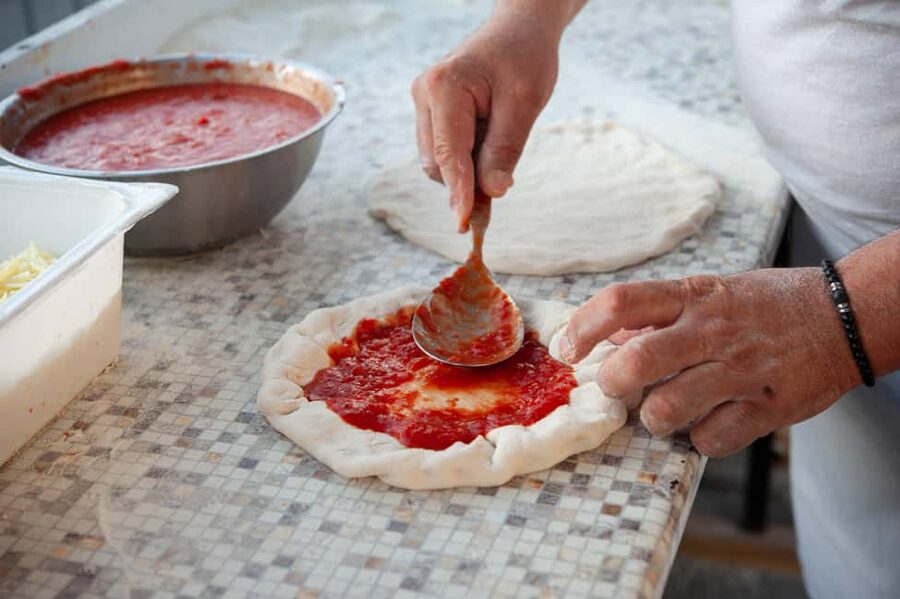 Amalfi Coast: Pizza & Mozzarella Class with Farmhouse visit - Adding toppings from the Amalfi garden