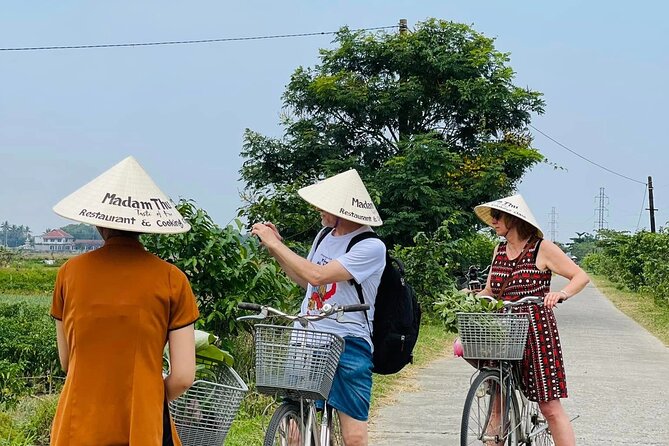 Hue Organic Farm Visit and Traditional Cooking Class - Working the soil at Madam Thu Farm