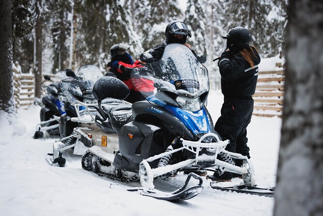 Husky and Reindeer Experience With Snowmobiling - Riding a snowmobile through the snowy forest