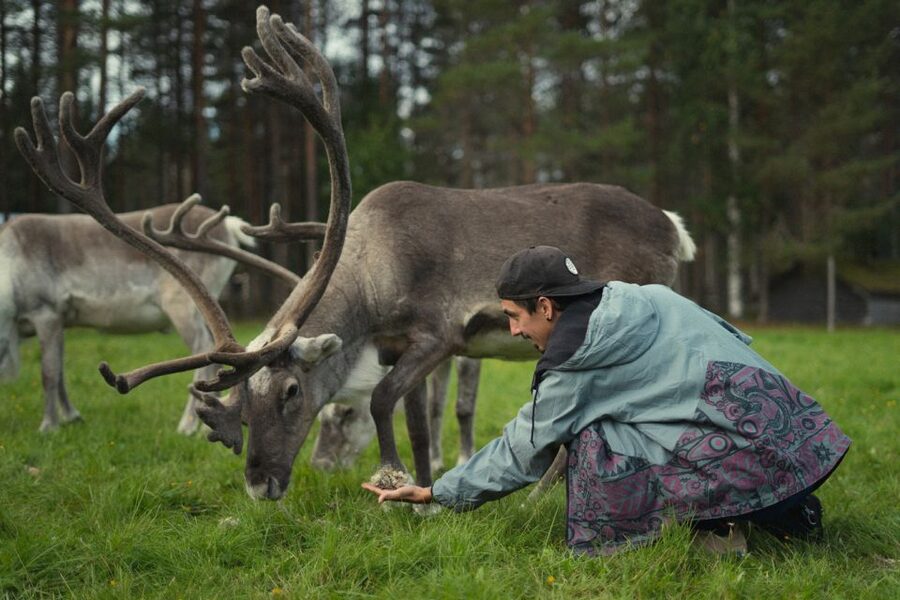 Rovaniemi: Reindeer Farm Visit with Photographer - Warming up beside the fire